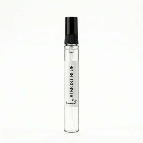 Small clear spray bottle labeled 'Almost Blue' on a white background