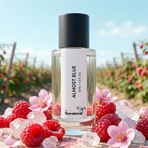 Bottle of 'Almost Blue' perfume with raspberries and flowers in a scenic outdoor setting
