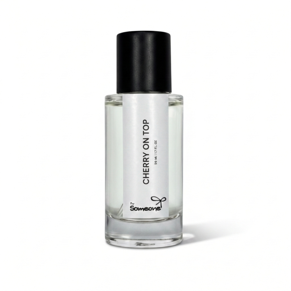 Clear perfume bottle with black cap labeled 'Cherry on Top' on a white background
